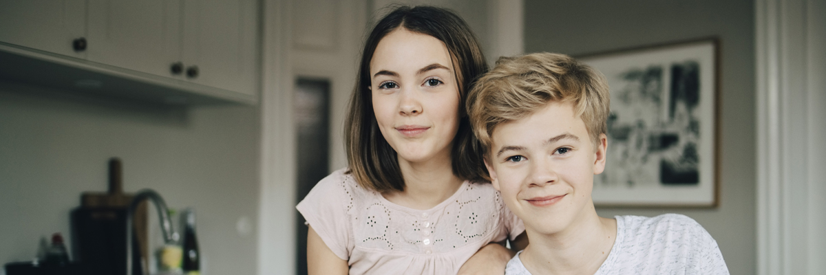 a boy and a girl looking at the camera